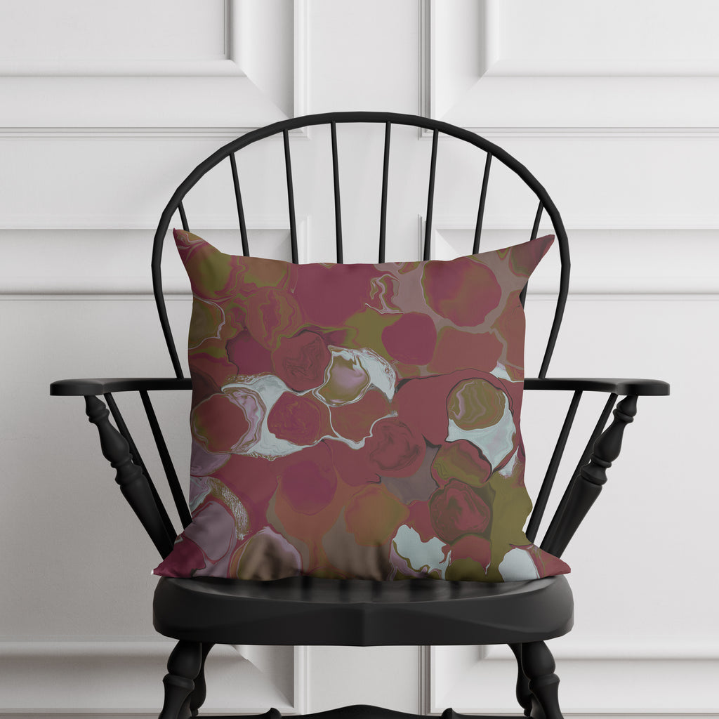 marblized pillow on a black chair against a white paneled wall